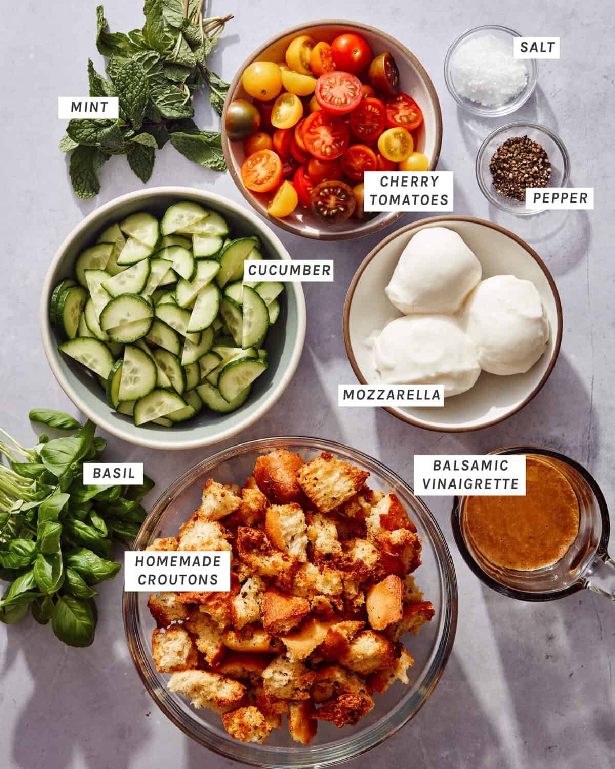 Ingredients to make a panzanella salad on a kitchen counter.