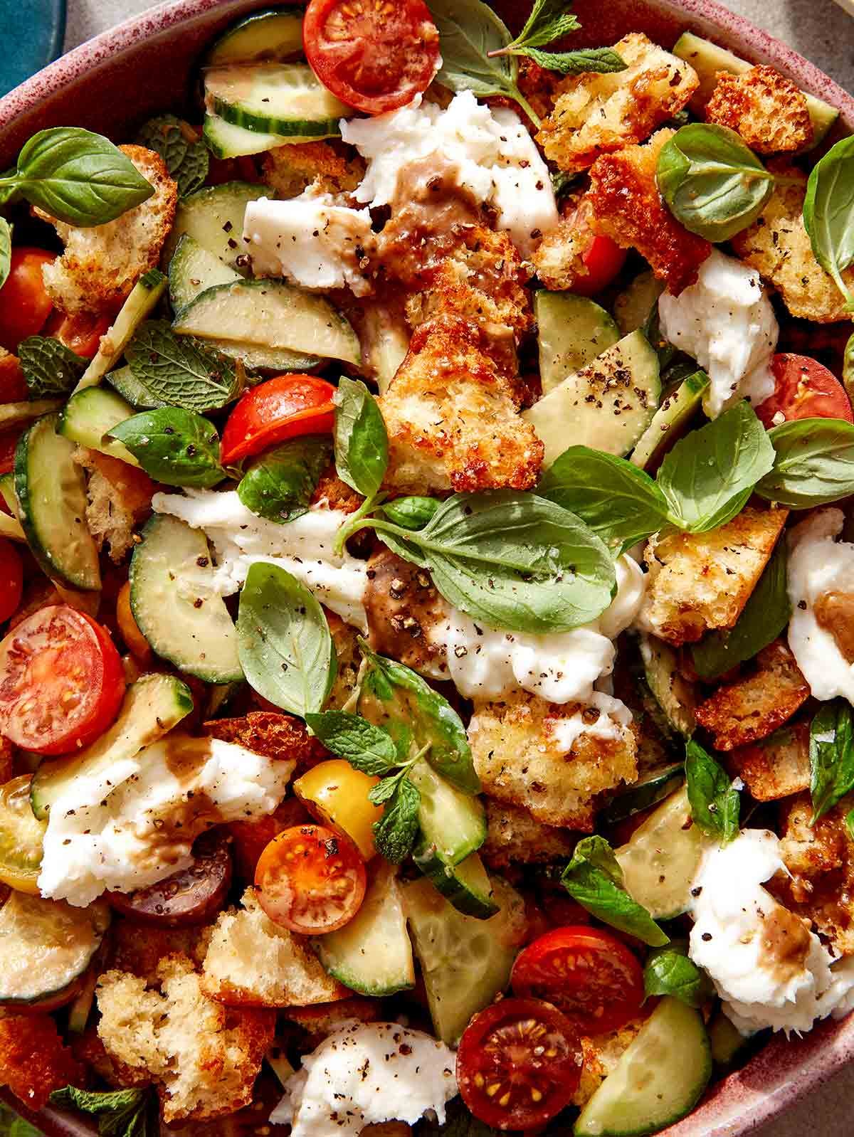 Close up on a bowl filled with panzanella salad.