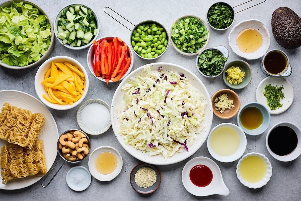 ingredients in bowls to make sesame noodle salad with honey sesame cashews.
