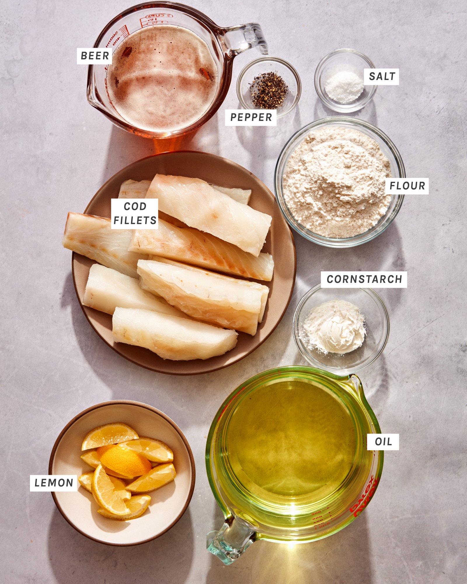 Ingredients to make beer battered fish at home on a kitchen counter.