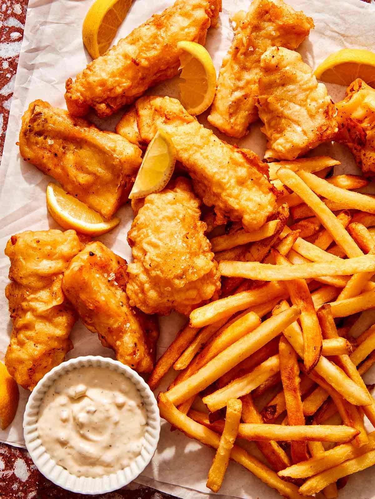 Beer battered fish with french fries and tartar sauce ready to be eaten.