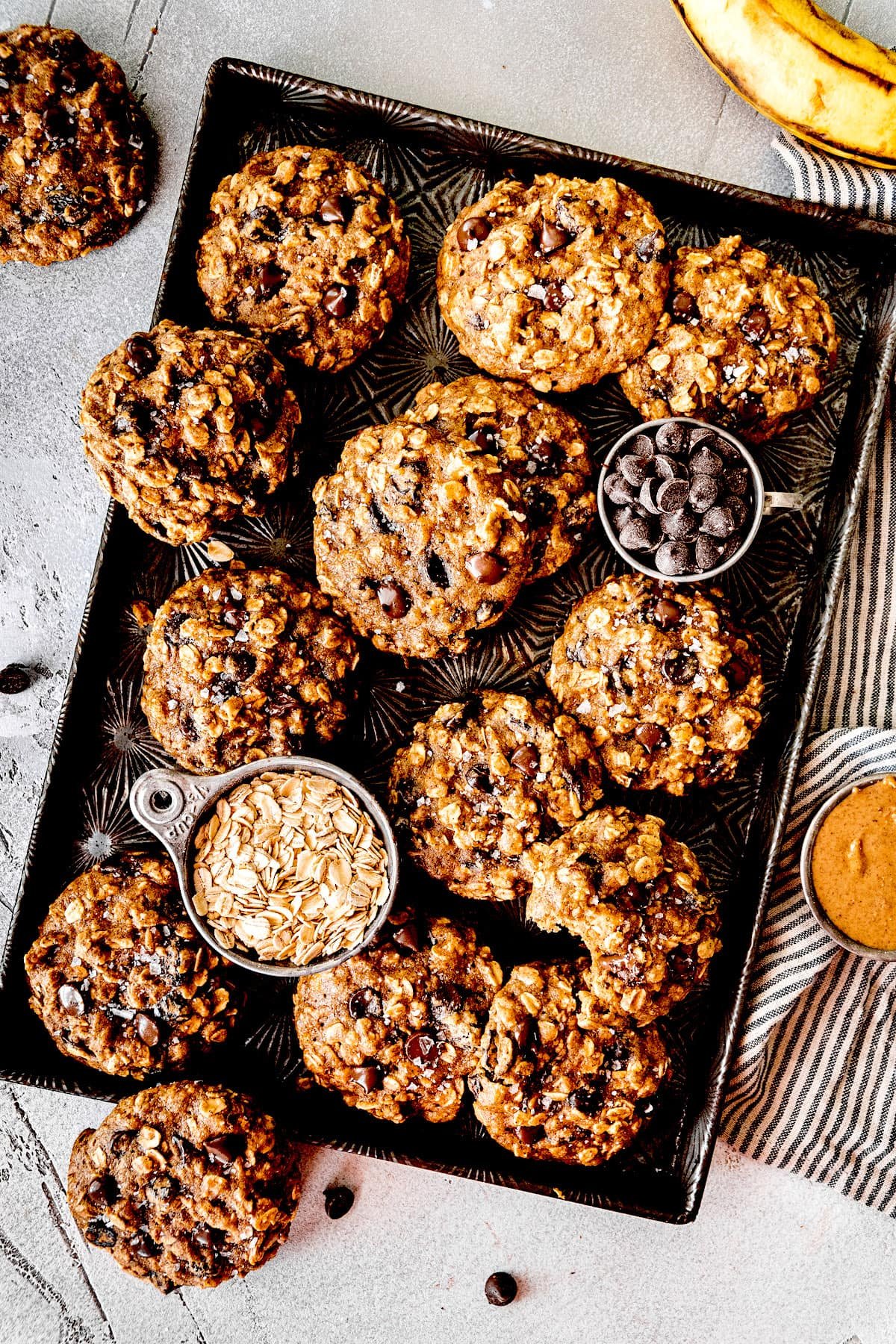 breakfast cookies with banana, oats, chocolate chips, and raisins on a baking sheet.