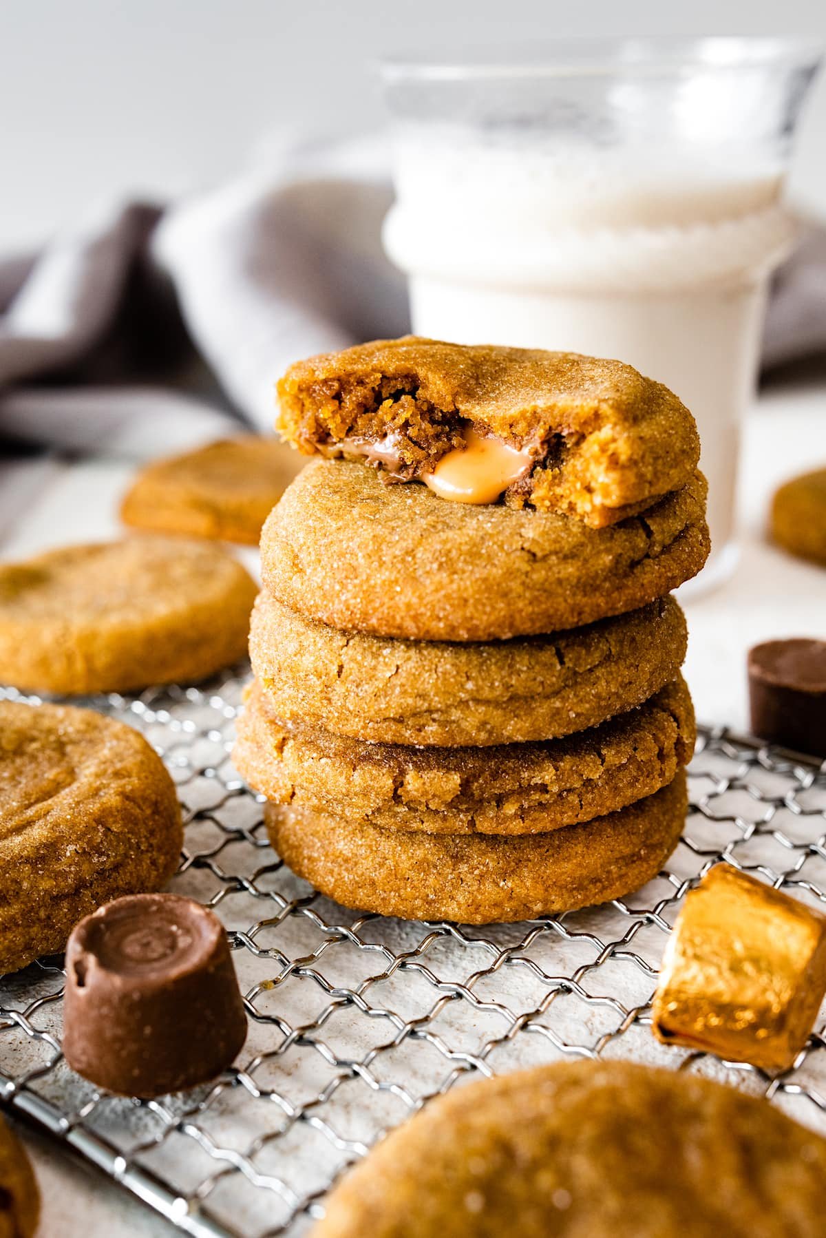 stack of ginger molasses cookies with rolo candy in the center.