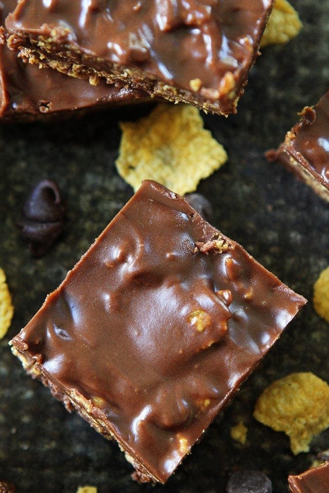 Crunchy No-Bake Chocolate Peanut Butter Bars Recipe on twopeasandtheirpod.com These bars are SO easy to make at home and are better than any store bought candy bar! They are our favorite easy treat! Crunchy No-Bake Chocolate Peanut Butter Bars Recipe