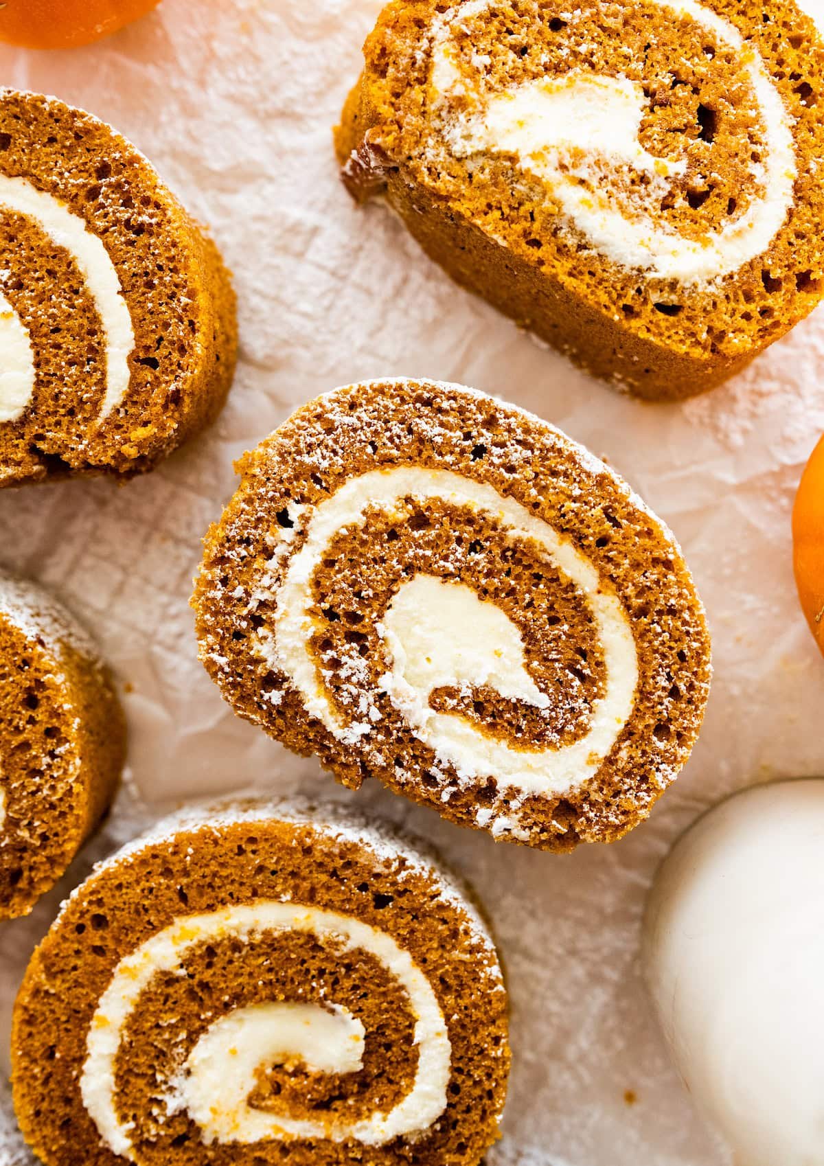 pumpkin roll with cream cheese filling cut into slices.