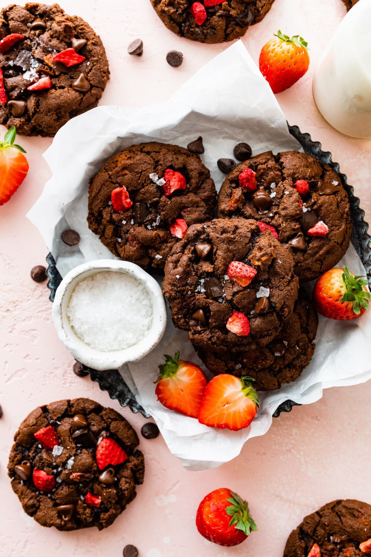 strawberry chocolate cookies with flaky sea salt in tray with parchment paper.