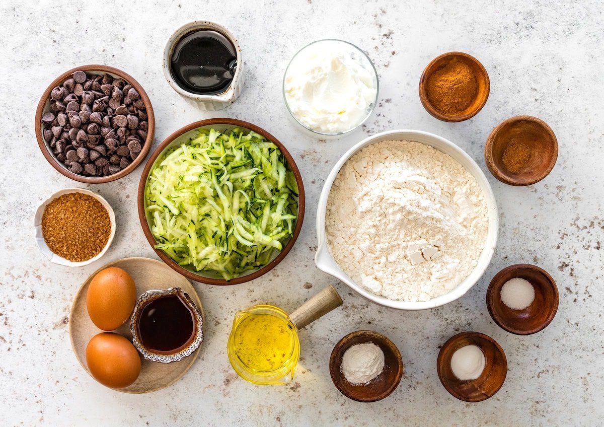 ingredients in bowls to make easy zucchini cake.