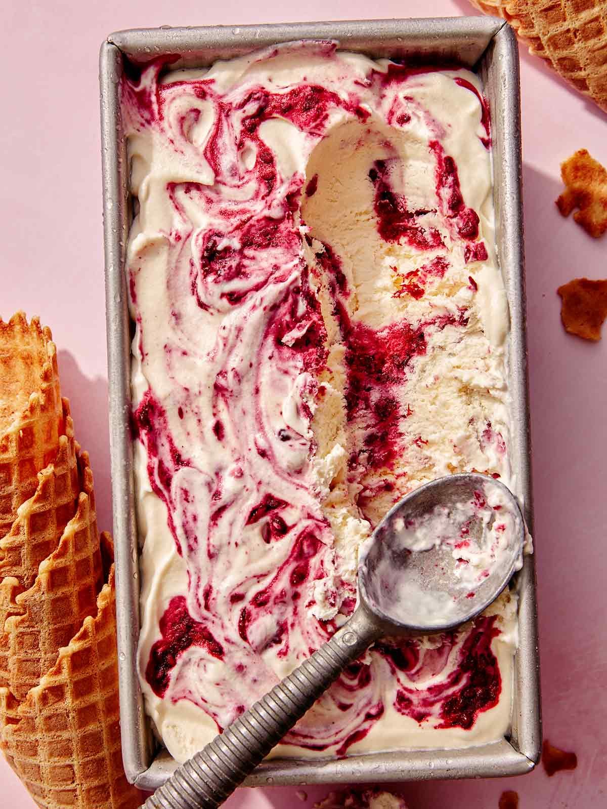 No churn ice cream in a loaf pan with a scoop taken out.