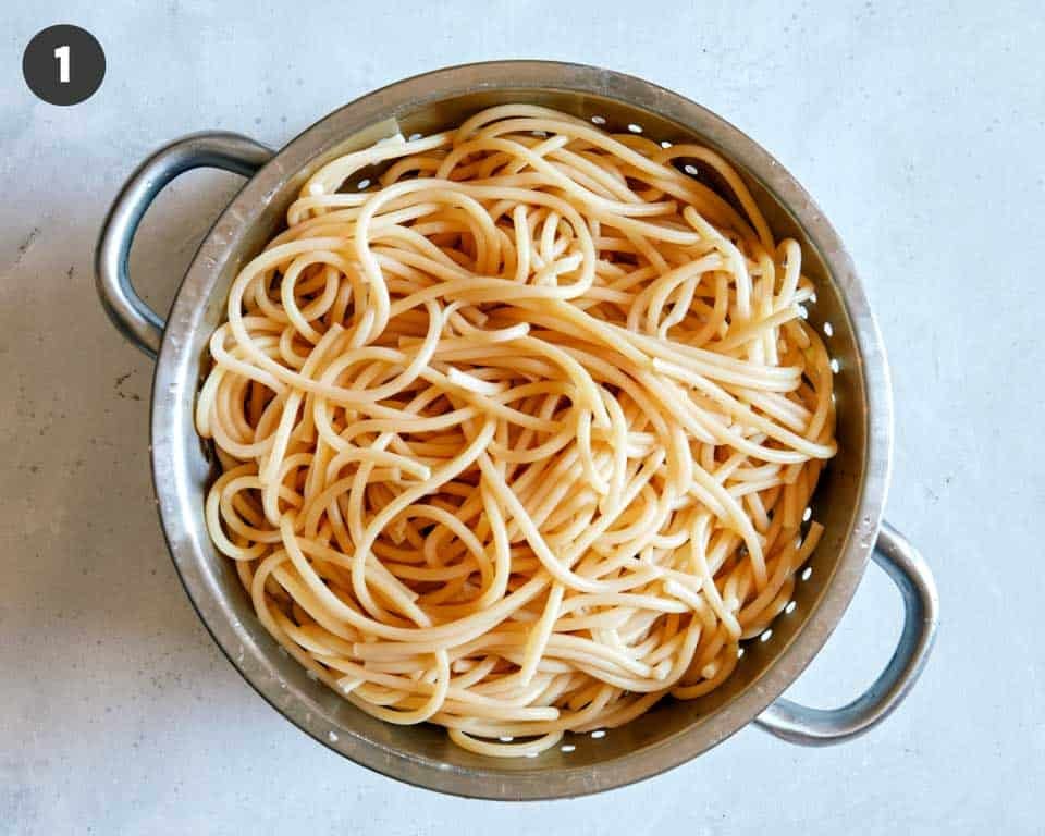 Cooked pasta in a colander. 