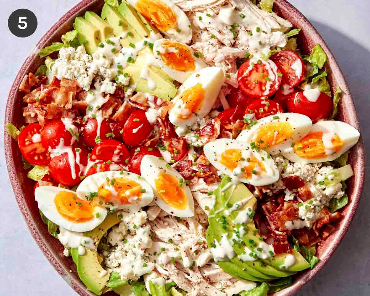 Cobb salad in a bowl with all the toppings.