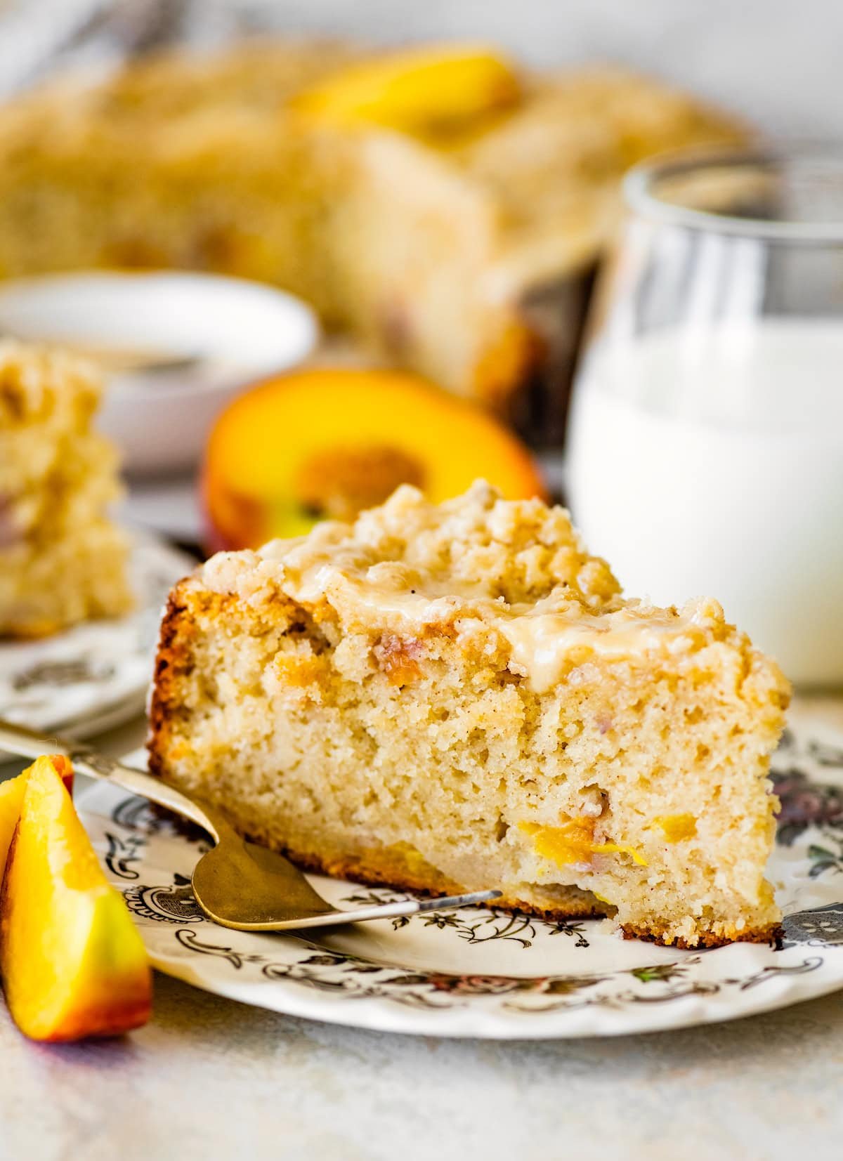 slice of peach ricotta cake on plate with fork. 