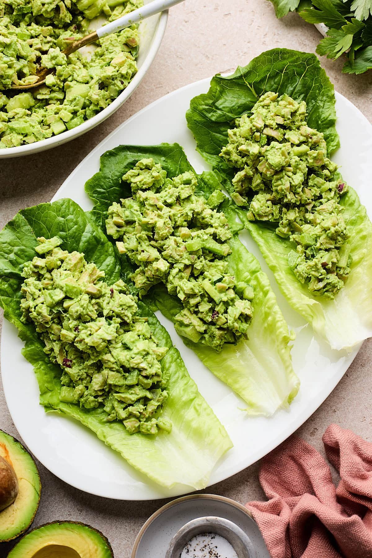 Green goddess chicken salad in romaine lettuce cups on plate. 