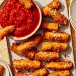 Fried zucchini on a platter being served to guests.