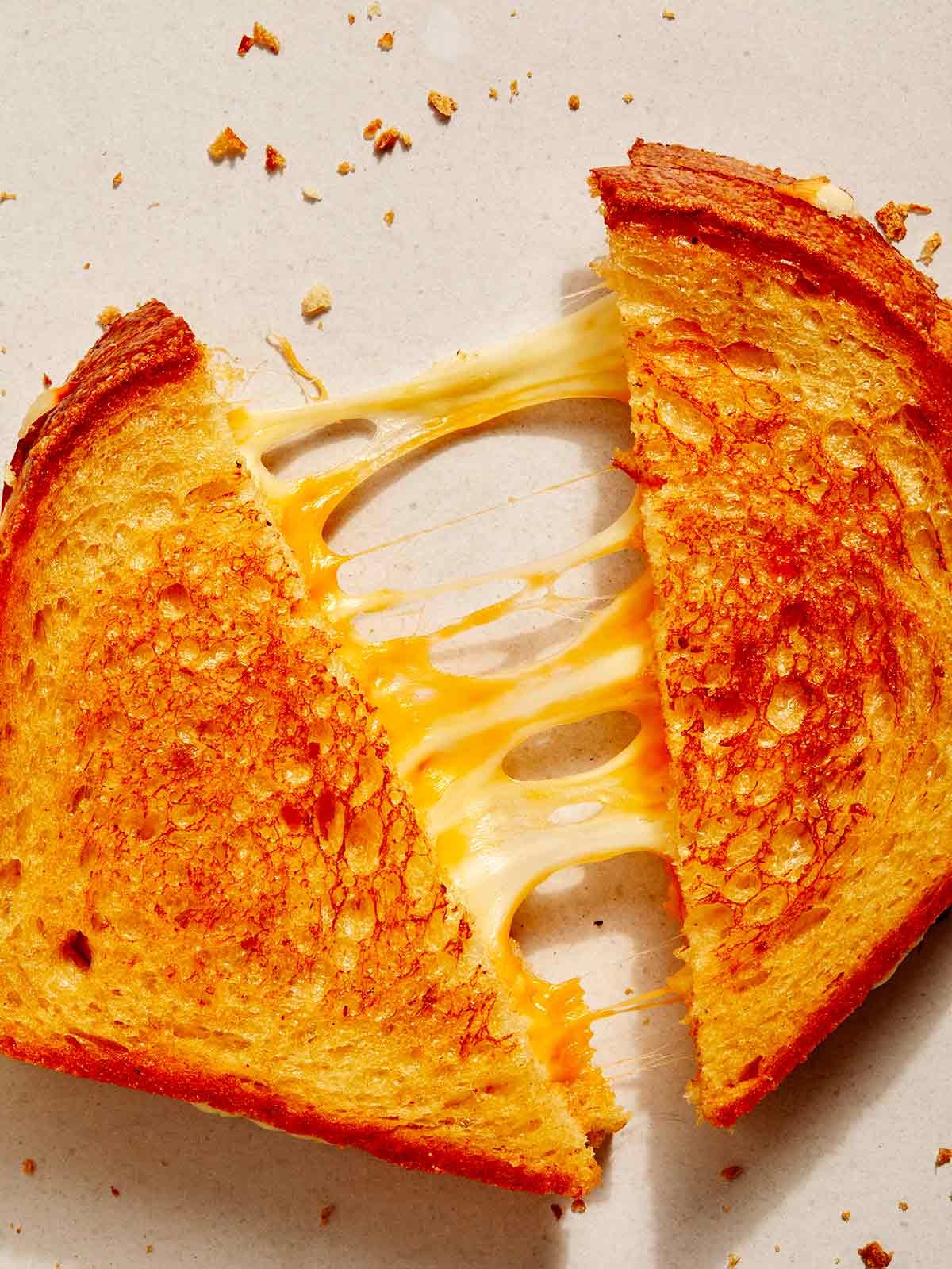 Perfect grilled cheese recipe close up on cheese pulls.