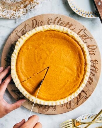 photo of cream cheese pumpkin pie being sliced by michelle of hummingbird high