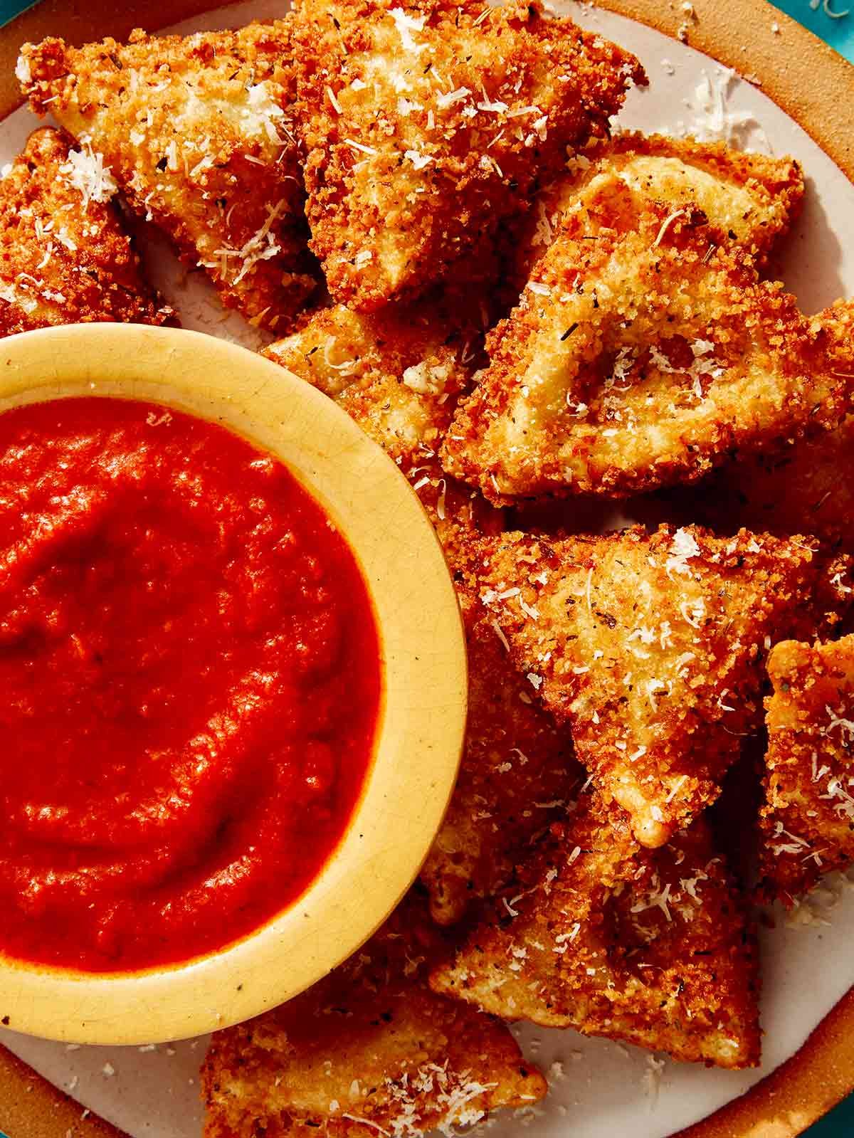 Close up on toasted ravioli with marinara sauce.