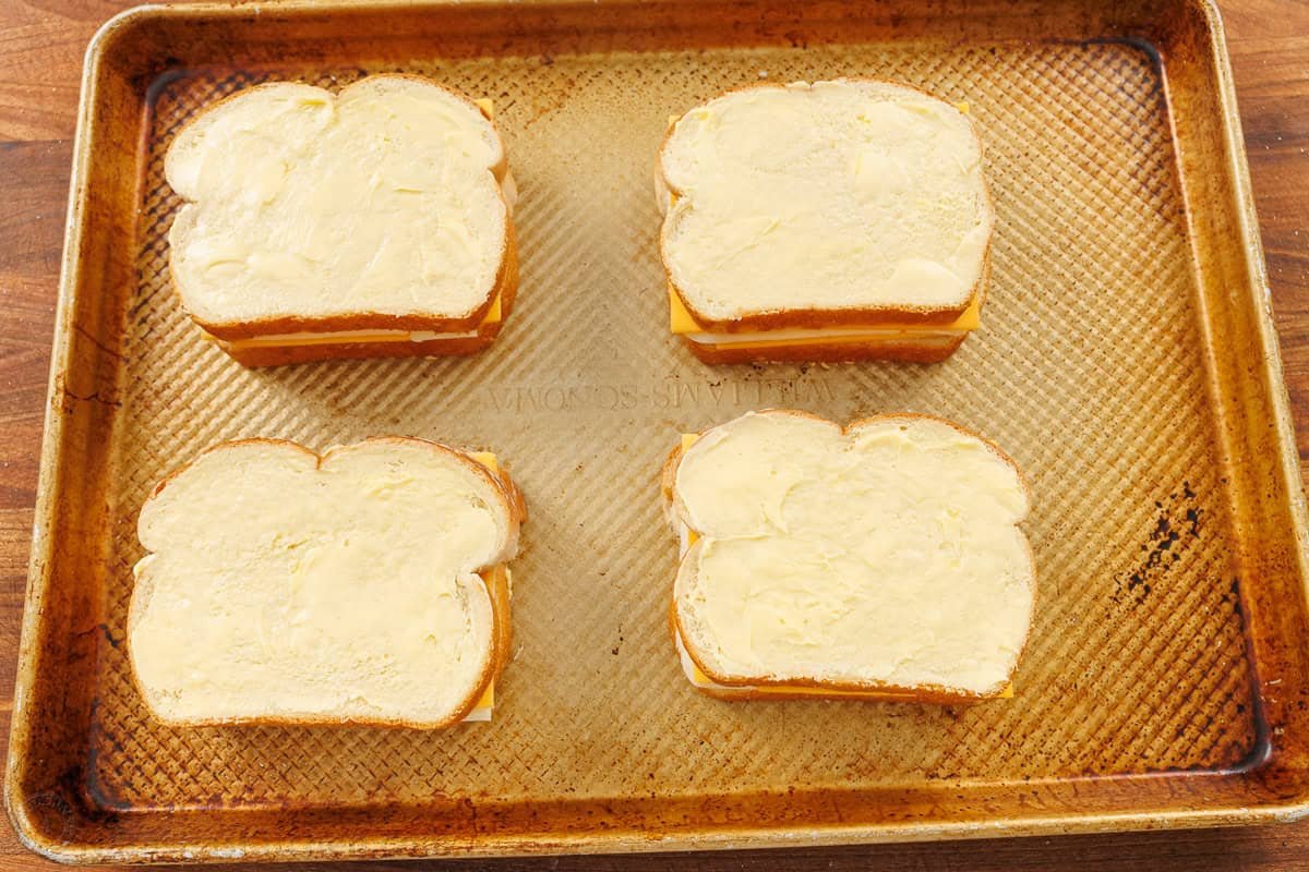 butter on the crust is the secret to the best grilled cheese in the oven