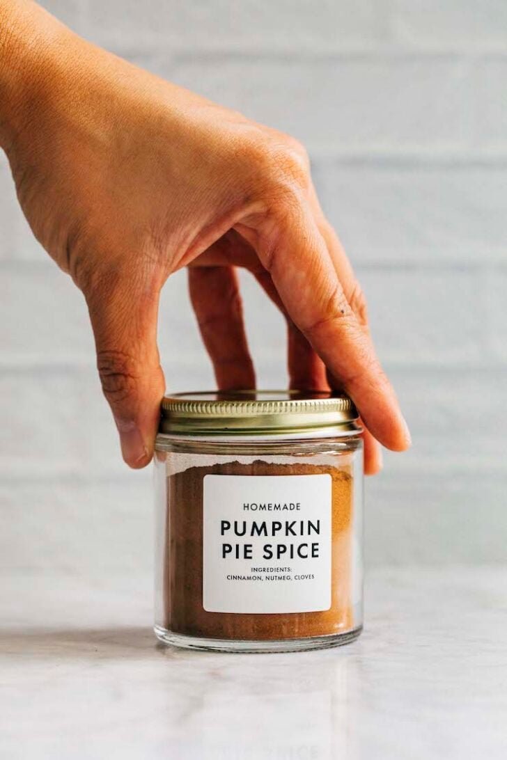 photo of hand setting down a jar of pumpkin pie spice