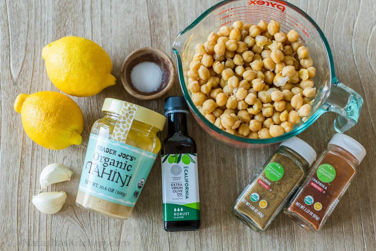 Ingredients for making authentic hummus with chickpeas, tahini, lemons, garlic, and olive oil
