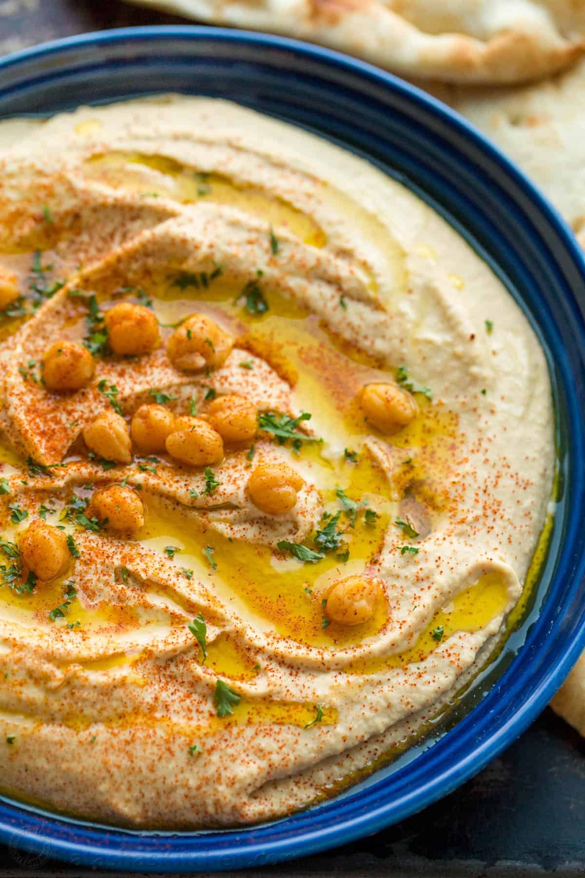 Freshly made hummus garnished with chickpeas, oil and paprika