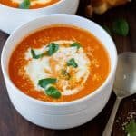 Roasted tomato soup garnished with cheese and cream