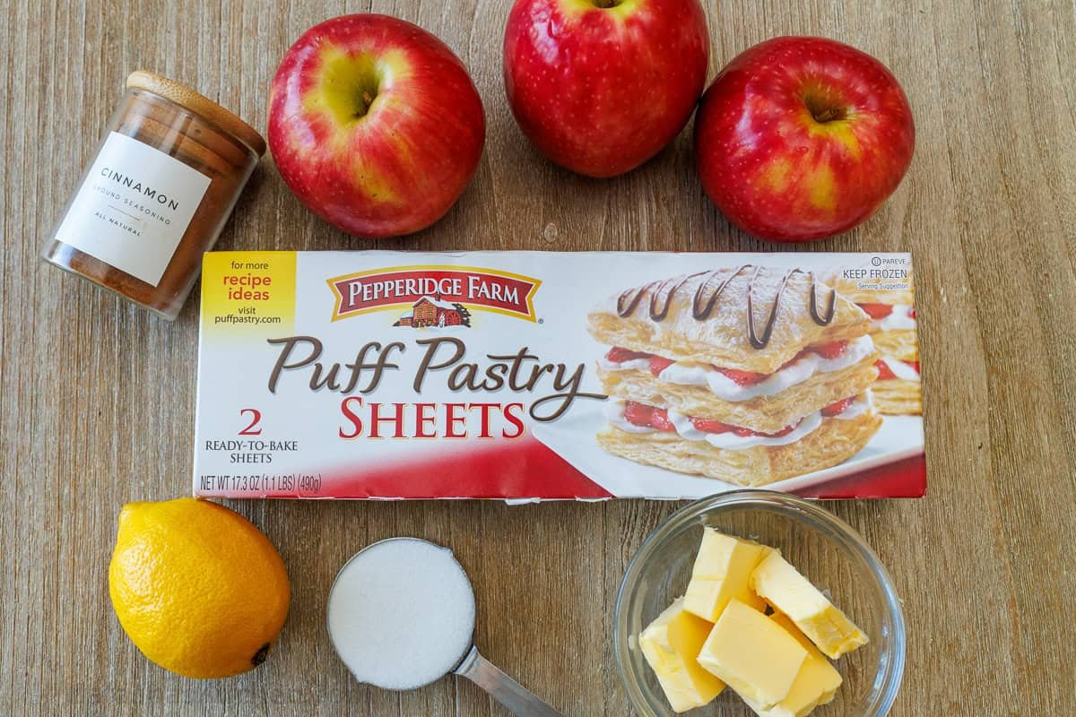 Easy Apple roses taste just like classic apple pie, but look festive and beautiful! Tey are easy to make and perfect as a holiday dessert. Ingredients for making apple dessert with puff pastry, cinnamon, lemon, sugar and butter