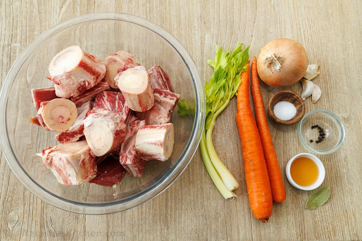Beef broth recipe ingredients including beef bones, celery, carrots, onion, salt, peppercorns, cider vinegar and bay leaf.