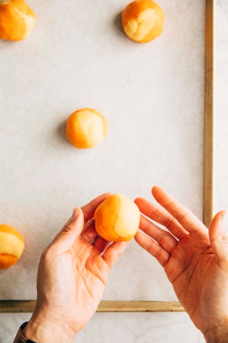 photo of Michelle from Hummingbird High showing the assembled unbaked Thai Tea cookie dough ball