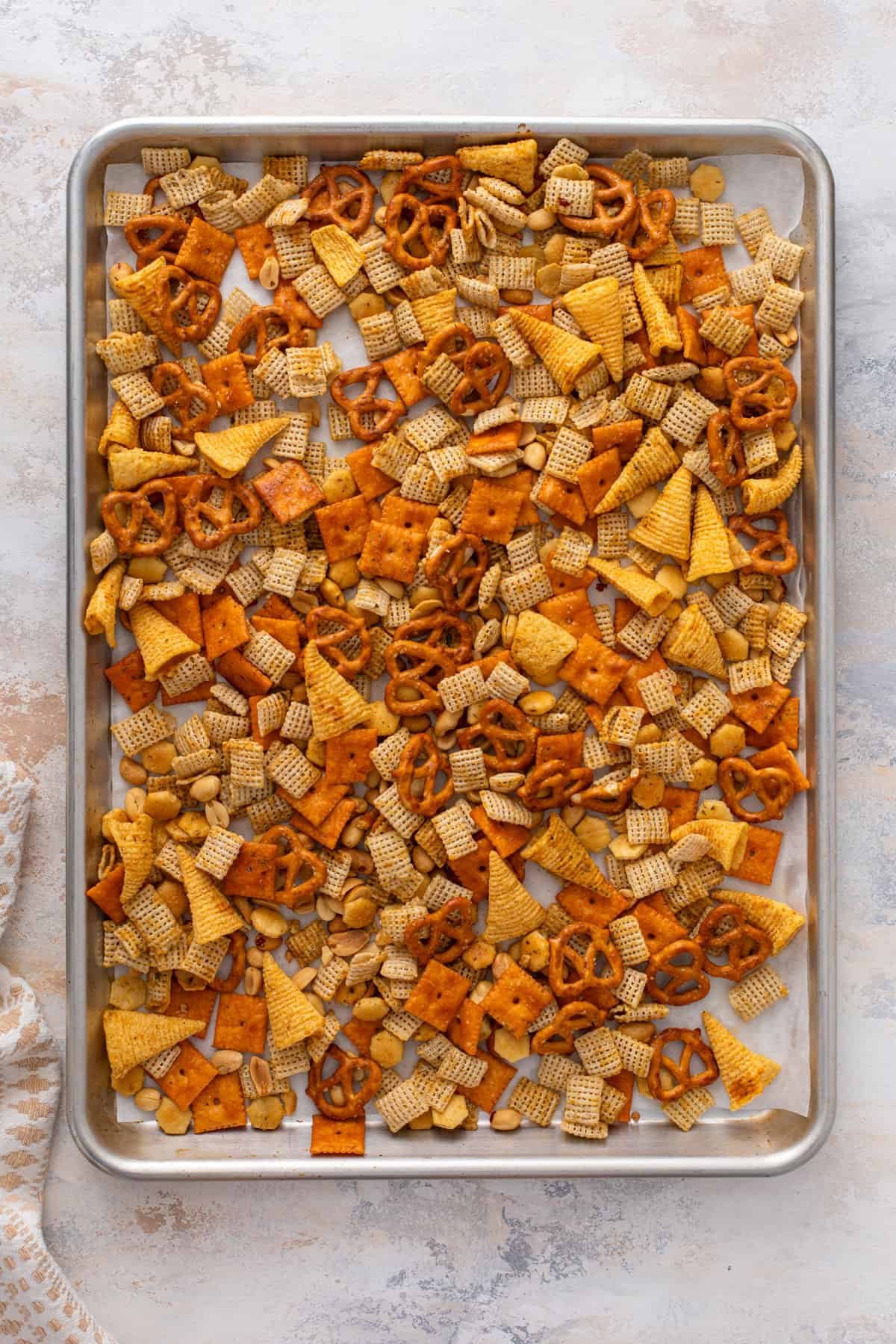Ranch chex mix on a rimmed baking sheet.