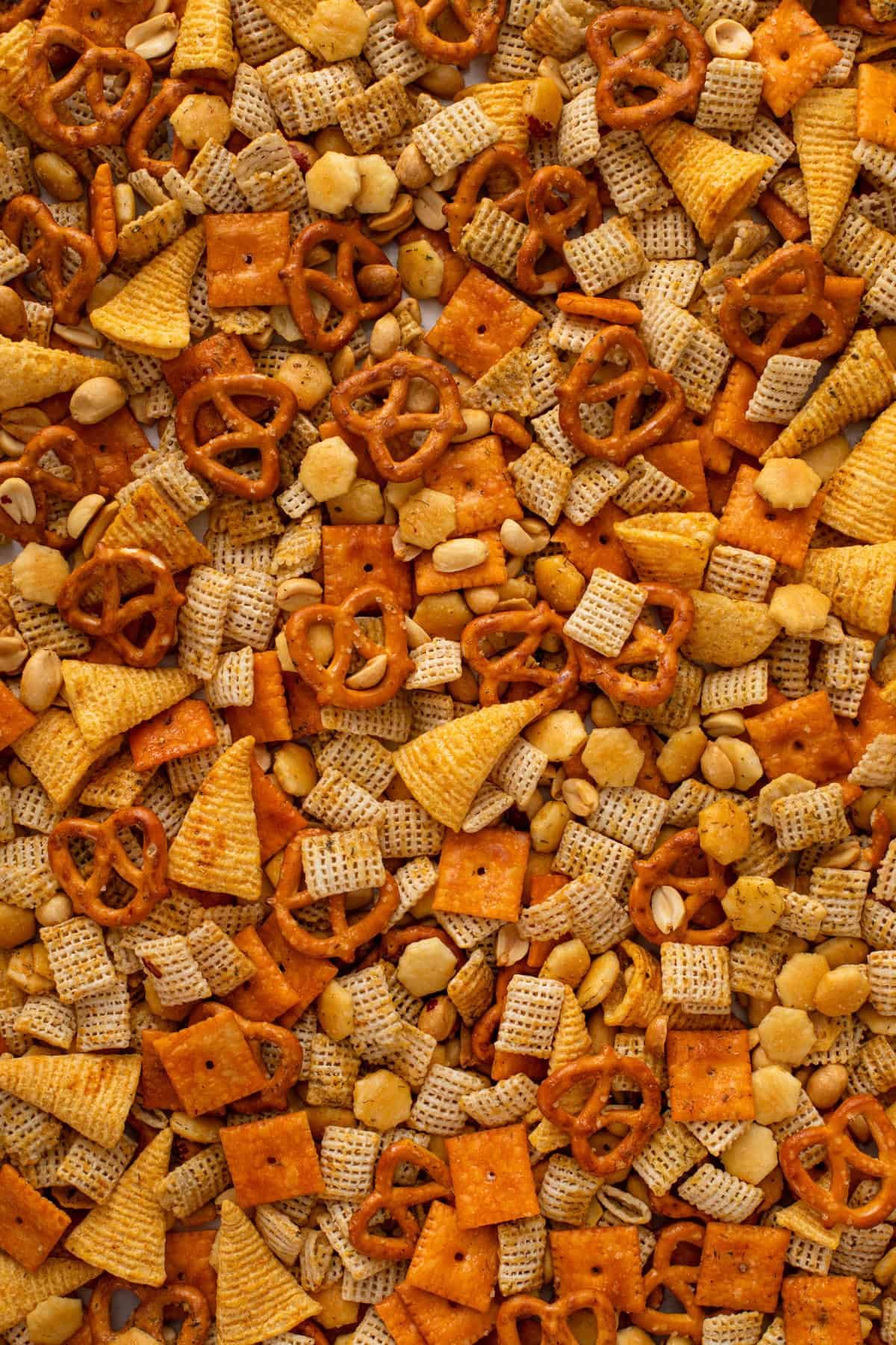 Close up of ranch chex mix spread into a layer on a sheet pan.