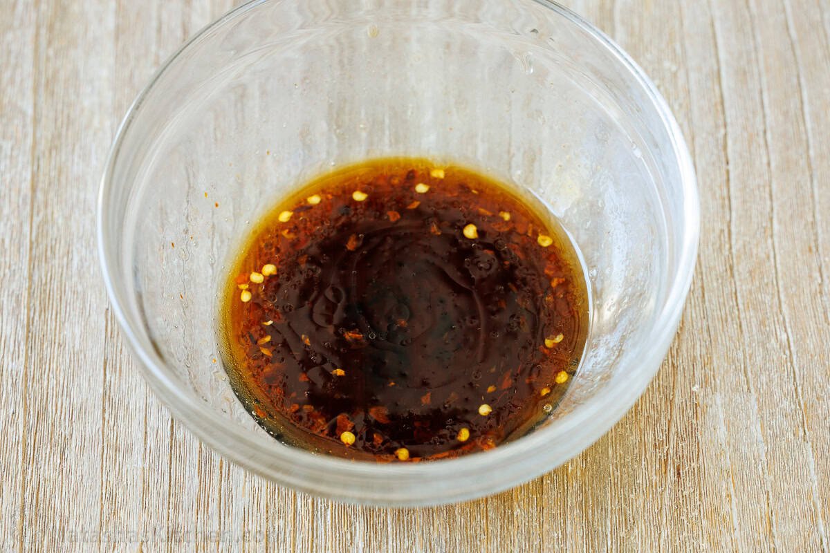 Spicy Korean Carrot Salad packs so much flavor into one crowd-pleasing side dish. The easy dressing melds the whole salad together in minutes. Korean dressing in a glass bowl