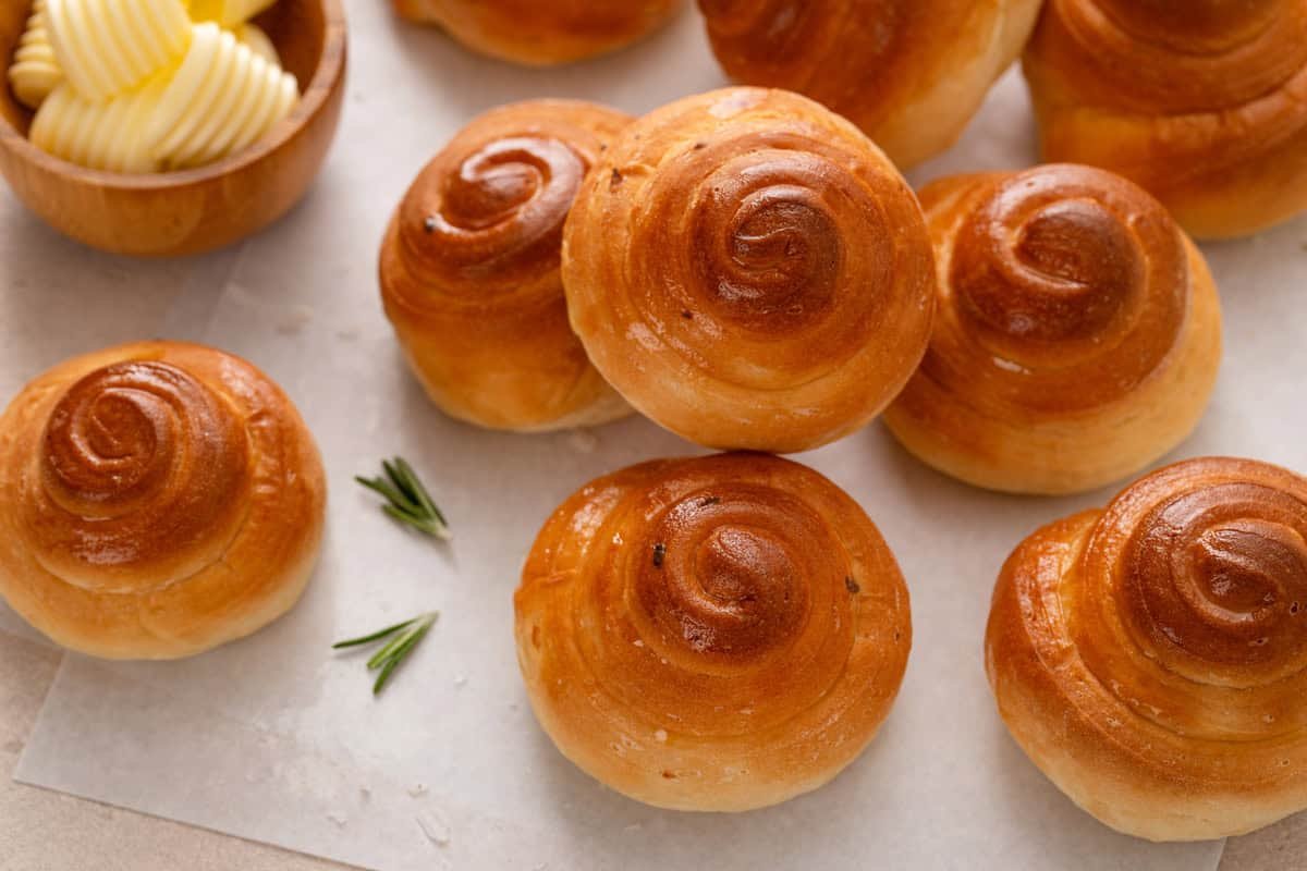 Baked curlicue rolls arranged on a countertop.