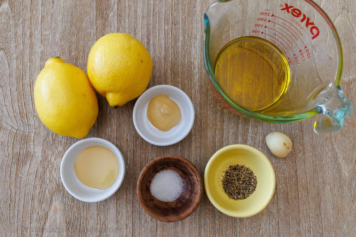 Lemon Vinaigrette dressing comes together quickly, but will become your go-to homemade salad dressing. Use for salads, to marinate, or more. ingredients for dressing a salad including dijon mustard, salt, pepper, garlic, honey, and olive oil