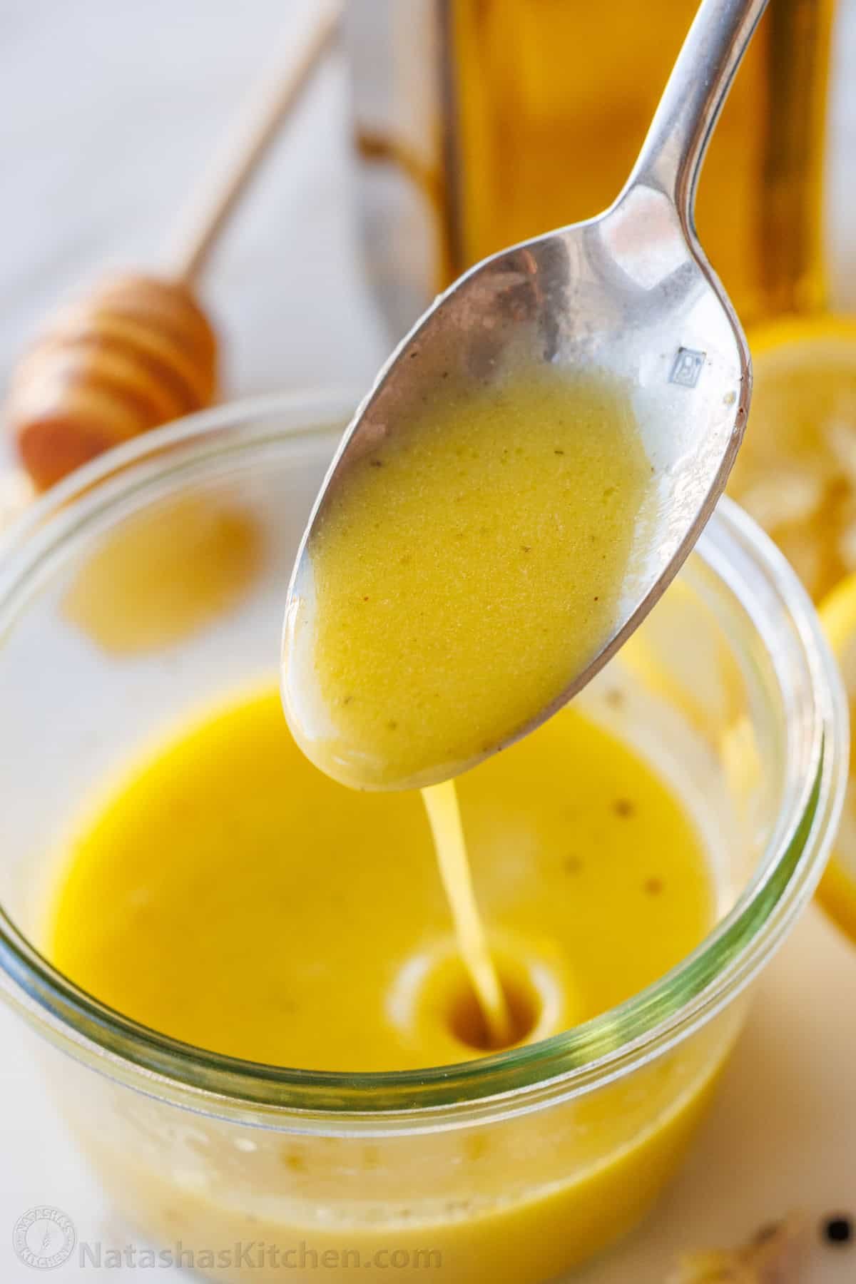 Lemon Vinaigrette dressing comes together quickly, but will become your go-to homemade salad dressing. Use for salads, to marinate, or more. a spoon drizzling Lemon vinaigrette dressing into a mason jar