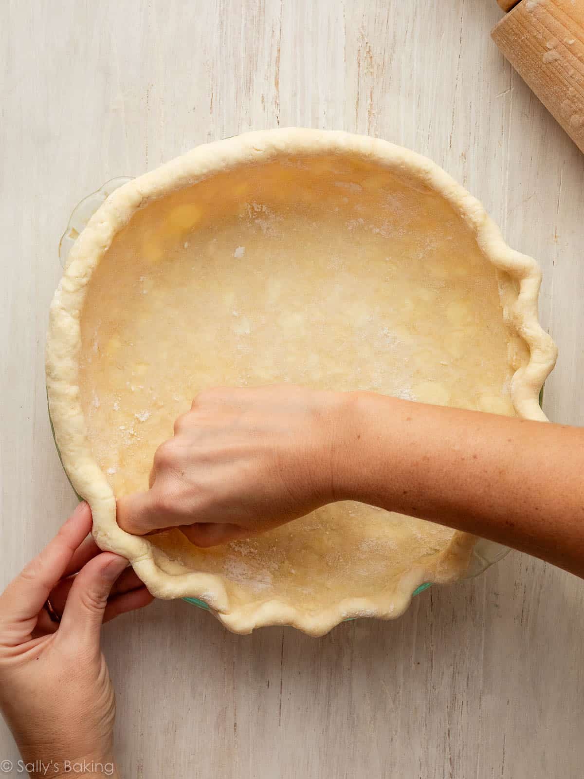 hands fluting pie crust.