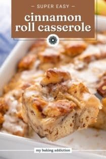 Slice of cinnamon roll casserole being lifted up by a cake server. Text overlay includes recipe name.
