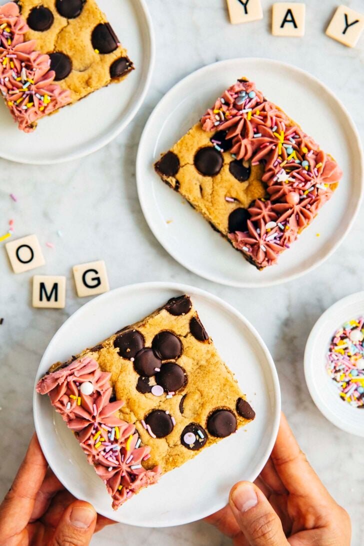 photo of Michelle from Hummingbird High holding up slices of cookie cake placed on white plates