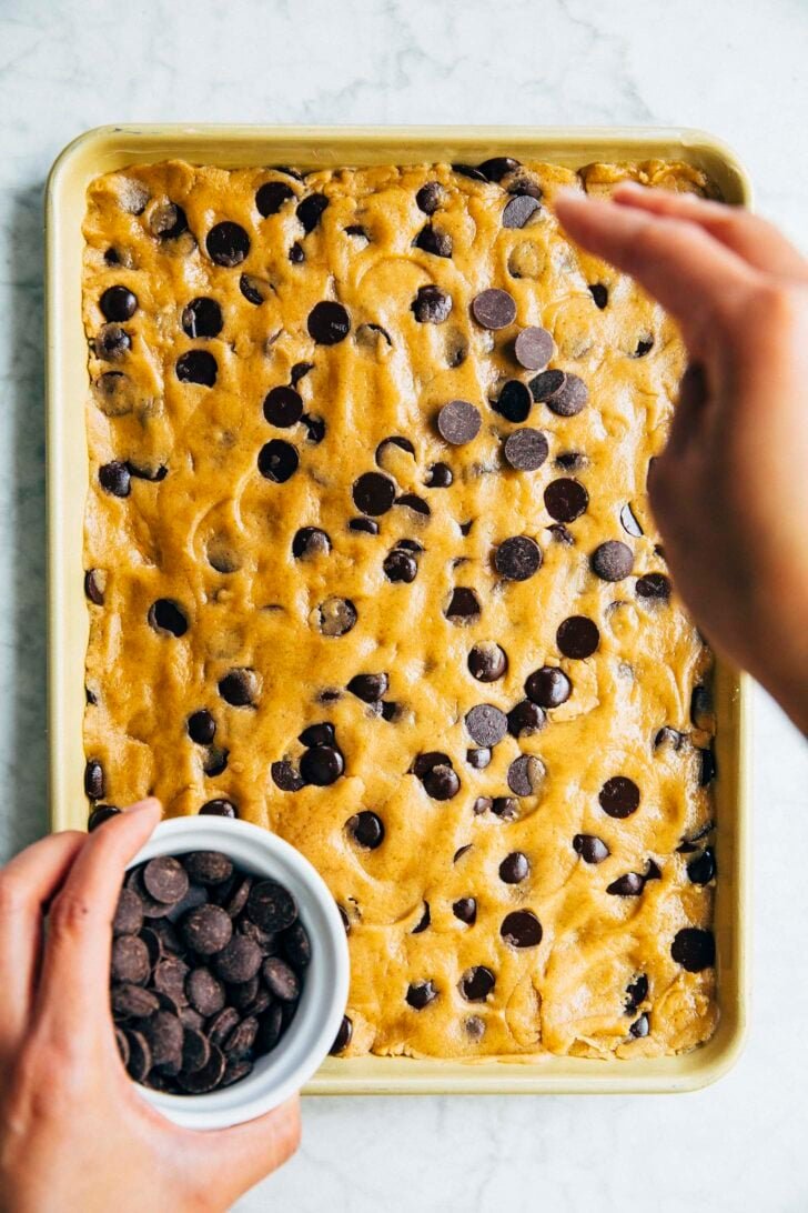 photo of michelle from hummingbird high scattering chocolate chips over the cookie dough
