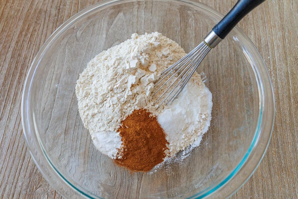 Bakery-style Apple muffins with crumb topping are so easy to make, with a moist crumb and chunks of apple inside. Uses just pantry staples. Whisk mixing dry ingredients in a clear bowl