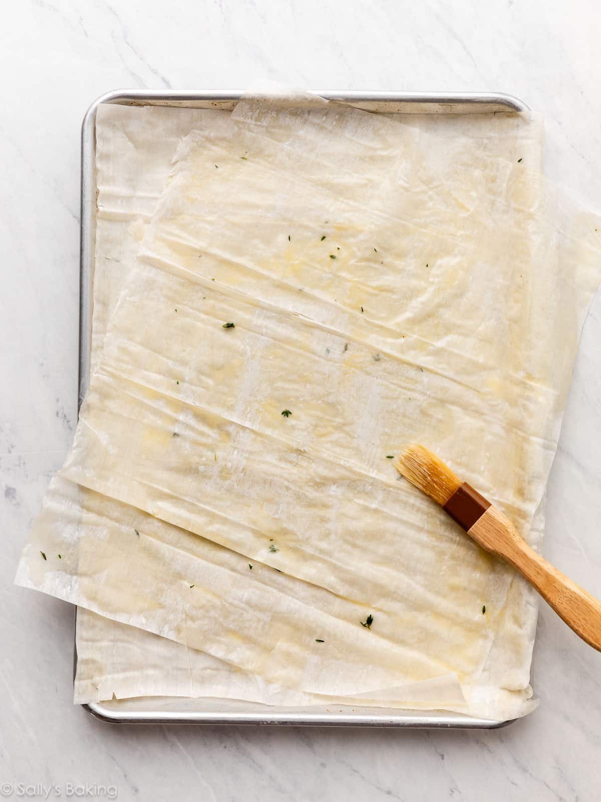 brush and thyme on dough.