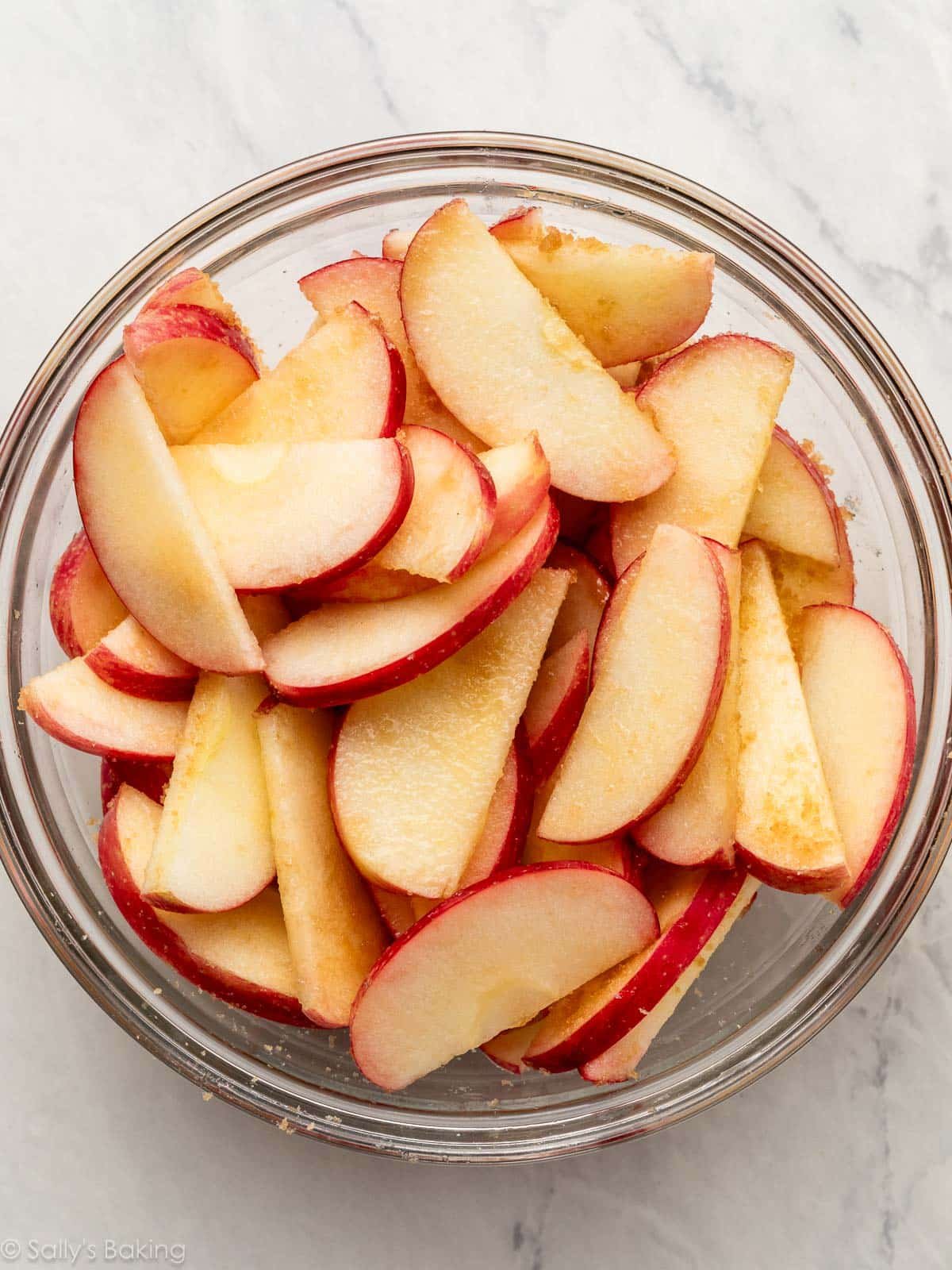 apple slices with brown sugar in bowl.