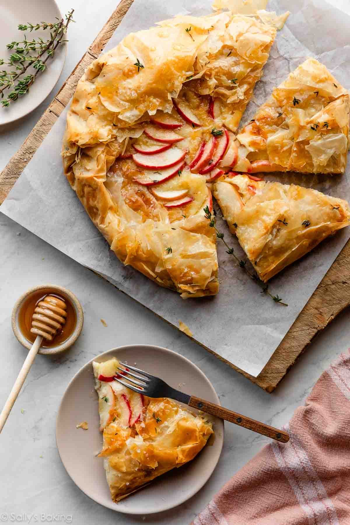 cut apple brie galette with slice on plate.