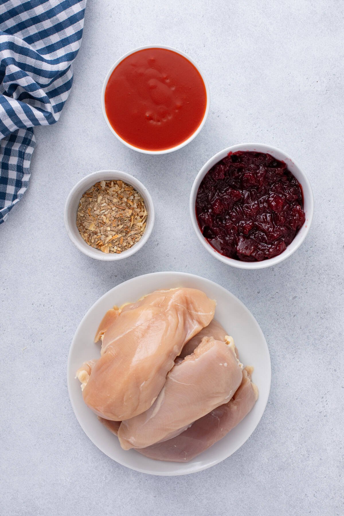 Ingredients for cranberry chicken arranged on a countertop.