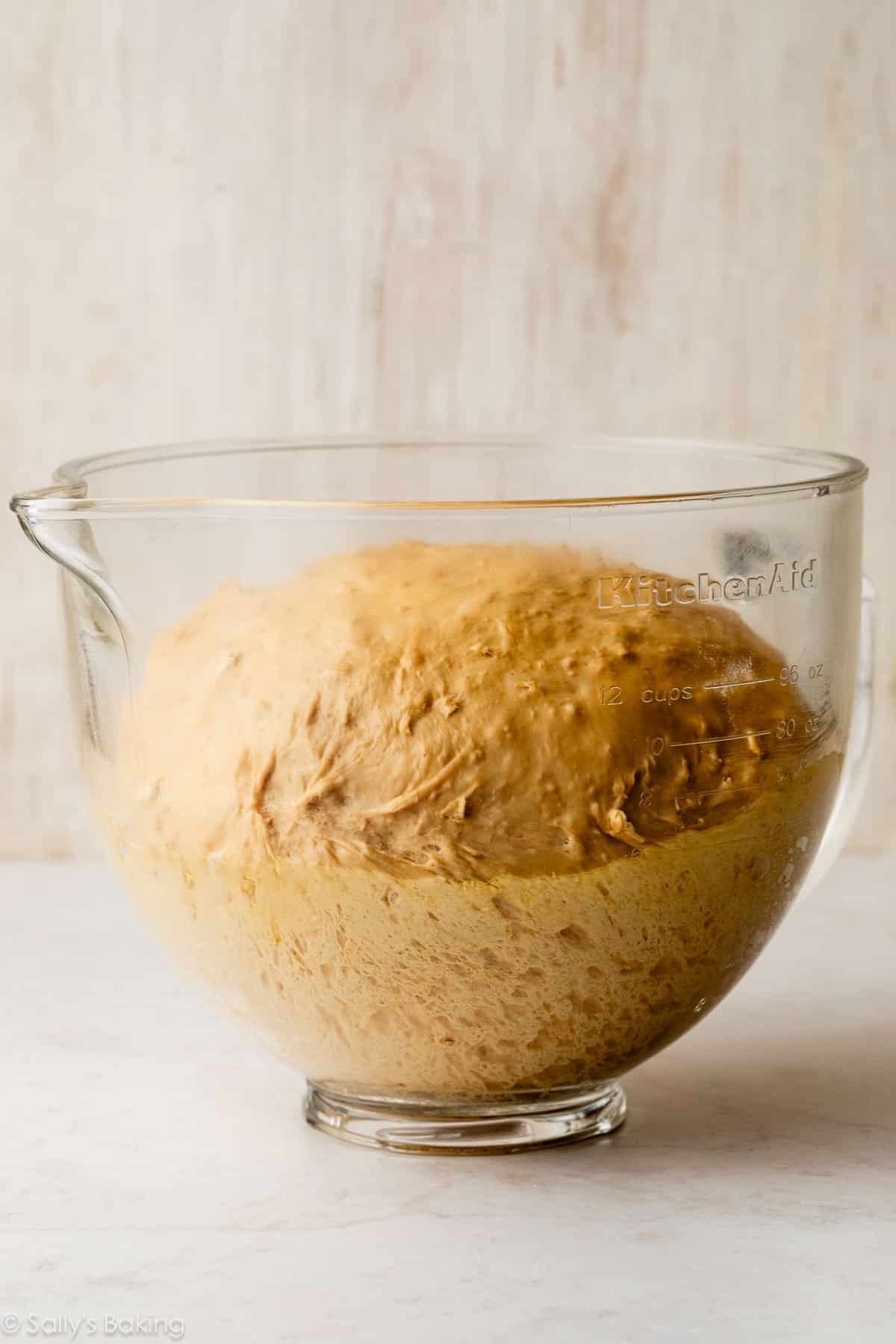 dough risen in glass bowl.