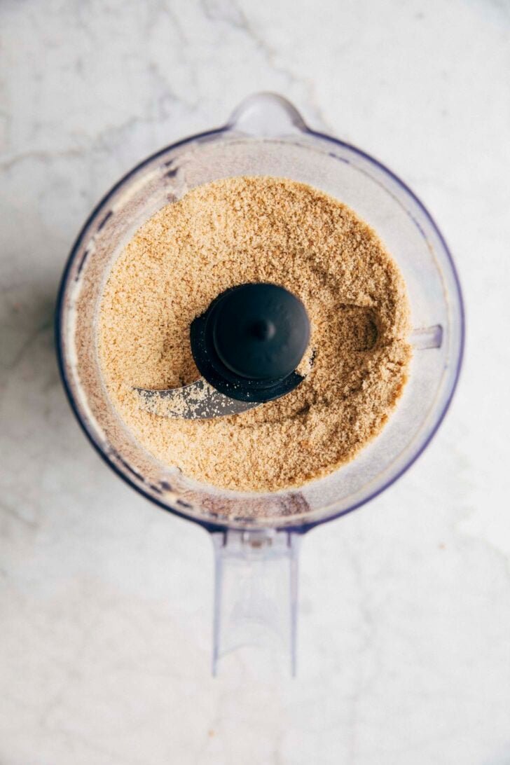 photo of graham crackers in a food processor bowl after being processed into crumbs