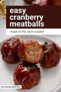 Bite taken from a cranberry meatball on an appetizer toothpick. text overlay includes recipe name.