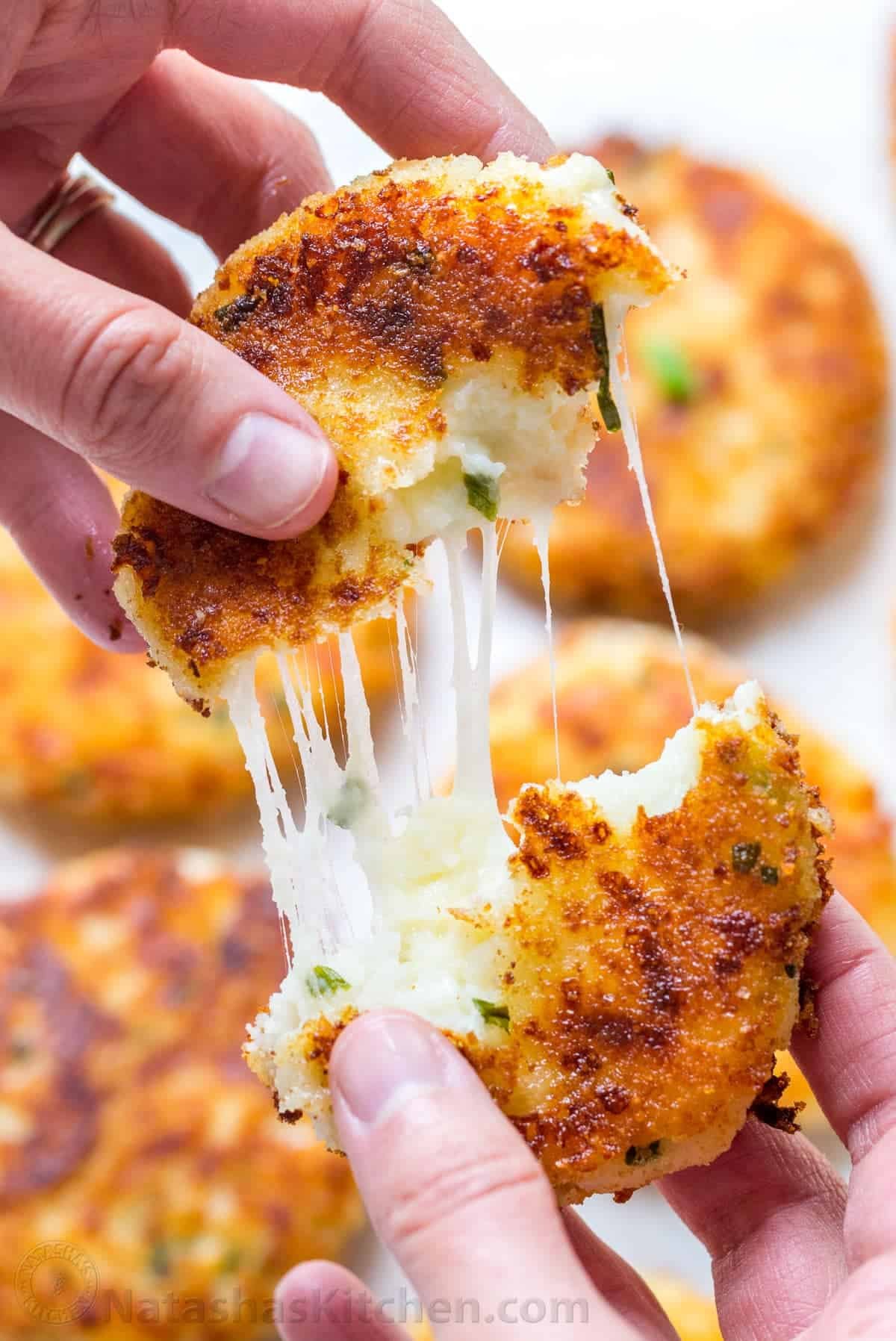 Cheesy mashed potato pancakes recipe - best way to use up leftover mashed potatoes! Mashed Potato Pancakes are crispy outside and loaded with melty cheese! | natashaskitchen.com