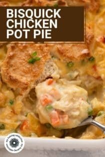 Spoon about to scoop up a serving of bisquick chicken pot pie from a baking dish. Text overlay includes recipe name.