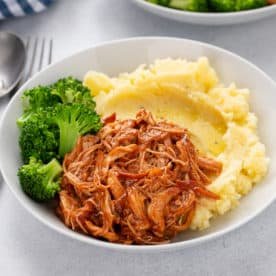Plated cranberry chicken with mashed potatoes and broccoli.