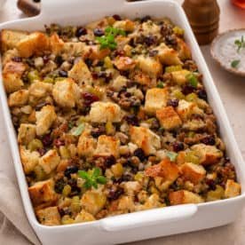 Sausage and cranberry stuffing in a white baking dish.